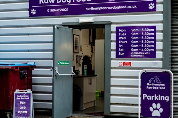 Entrance to Northampton Raw Dog Food with opening hours displayed